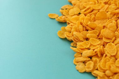 Kahvaltı gevreklerinin arka planında büyük miktarda mavi arka planda yakın plan, üst manzara.