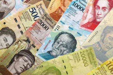 Venezuelan Bolivar currency money bills in pile. VED currency banknotes with different denomination close up