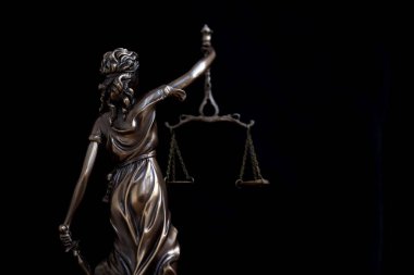 Lady Justice large statue in law on black backdrop. Law and justice concept