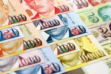 Singapore Dollar currency money bills. SGD currency banknotes in bunch with different denomination close up