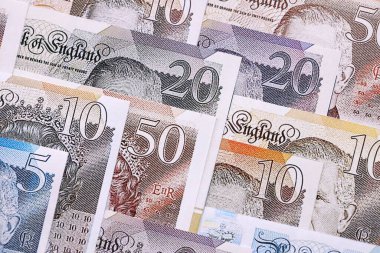 British pounds currency money bills in big amount. Many GBP currency banknotes with different denomination close up