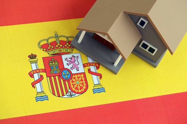 Residential house on Spanish flag close up. Concept of Squatting in Spain. Okupas problem
