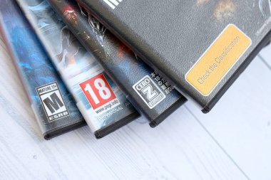 KYIV, UKRAINE - SEPTEMBER 8, 2025 ESRB PEGI and CERO game ratings on different videogames close up. American, European and Japanese age rating marks