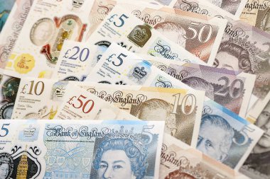 KYIV, UKRAINE - SEPTEMBER 17, 2025 Big amount of British pound money bills on table close up