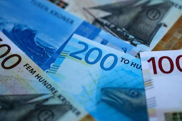 Norwegian Krone currency money bills. NOK currency banknotes in heap with different denomination close up