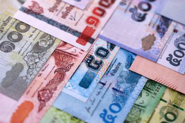 Thai Baht currency money bills. THB currency banknotes in pile with different denomination close up