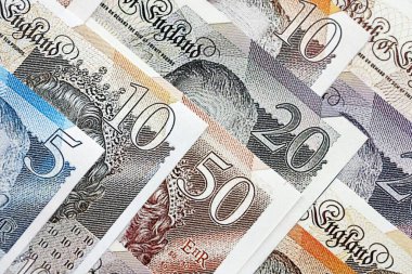 British pounds currency money bills in big amount. Many GBP currency banknotes with different denomination close up