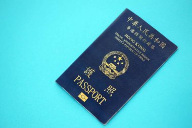 Hong Kong Special Administrative Region HKSAR Passport lies on blue table background close up. Hong Kong blue new passport book in details