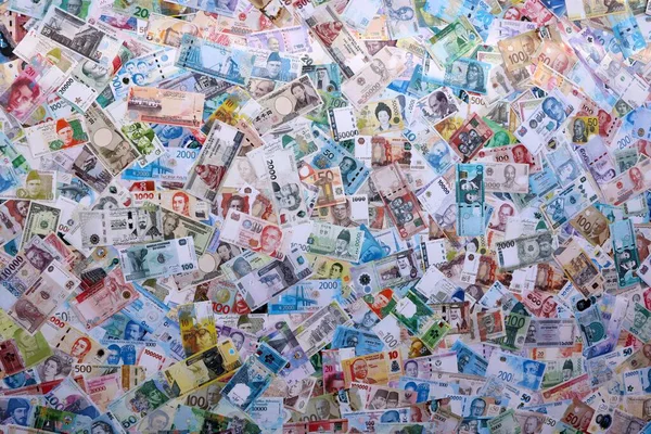 Farklı para birimlerinden bir sürü banknot. Rastgele gelen büyük miktarlarda para kapanıyor. Döviz Borsası kavramı