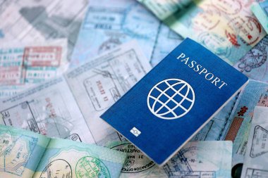 Seyahat ve sınır geçişinden sonra içi renkli pullarla dolu bir pasaport. Turizm ve sınır denetimi kavramı. Göçmenlik ve dünya çapında seyahat