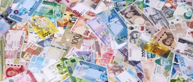 Dünyanın çeşitli para birimlerinden farklı banknotlar. Masada bir sürü para var. Yakın plan.