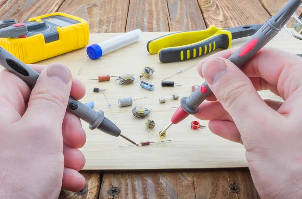 The workplace of serviceman. Hands holding the probes. — Stock Photo, Image