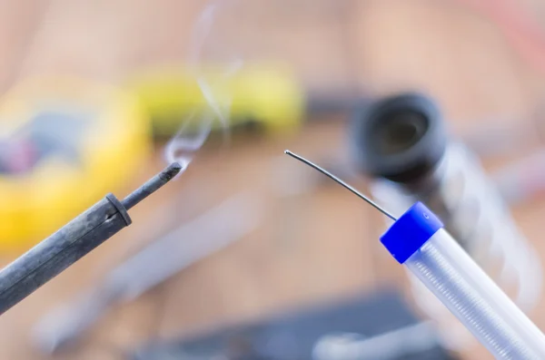 The incandescent soldering-iron and solder — Stock Photo, Image
