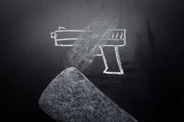 Weapon draw erased on blackboard - no violence concept — Stock Photo, Image