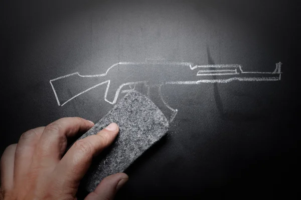 Weapon draw erased on blackboard - no violence concept — Stock Photo, Image