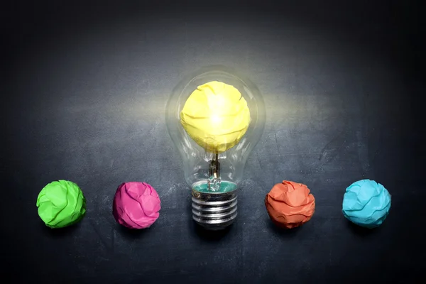 Light-bulb-crumpled-paper-on-blackboard-idea-concept-background — Stock Photo, Image