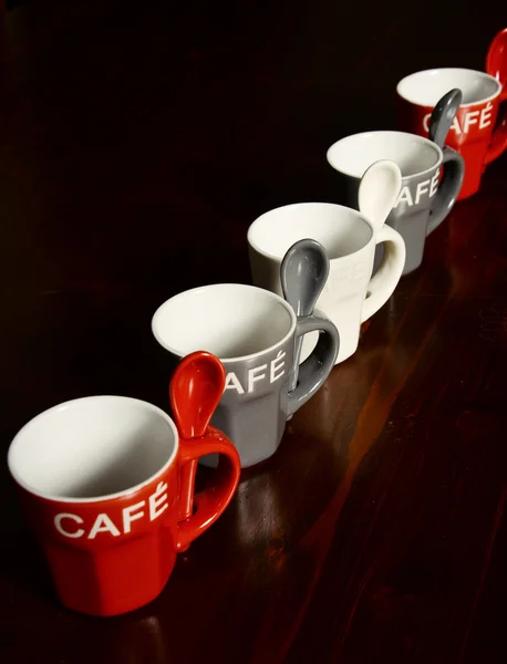 Colored Coffee cups on wooden table — Stock Photo, Image