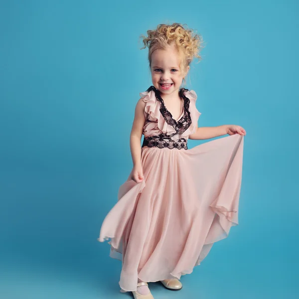 Niña en un vestido largo y un abrigo de piel — Foto de Stock