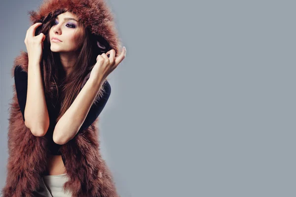 Portrait of attractive stylish woman in fur against grey background. Stock Image