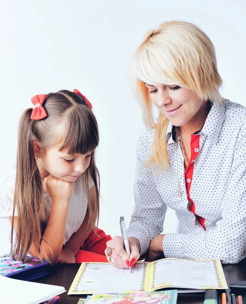 Little girl draws a teenage student decides to write homework wi — Stock Photo, Image