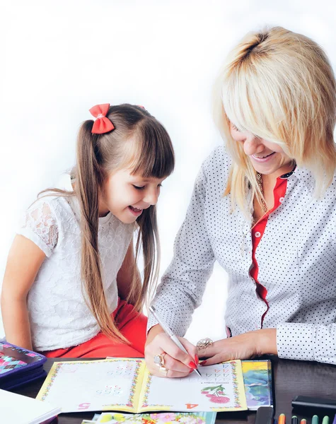 Little girl draws a teenage student decides to write homework wi — Stock Photo, Image