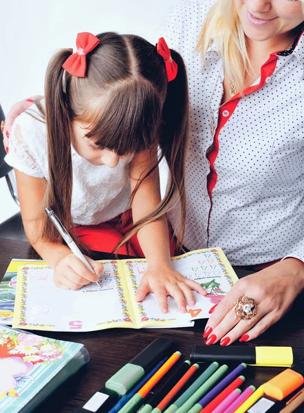 Little girl draws a teenage student decides to write homework wi — Stock Photo, Image