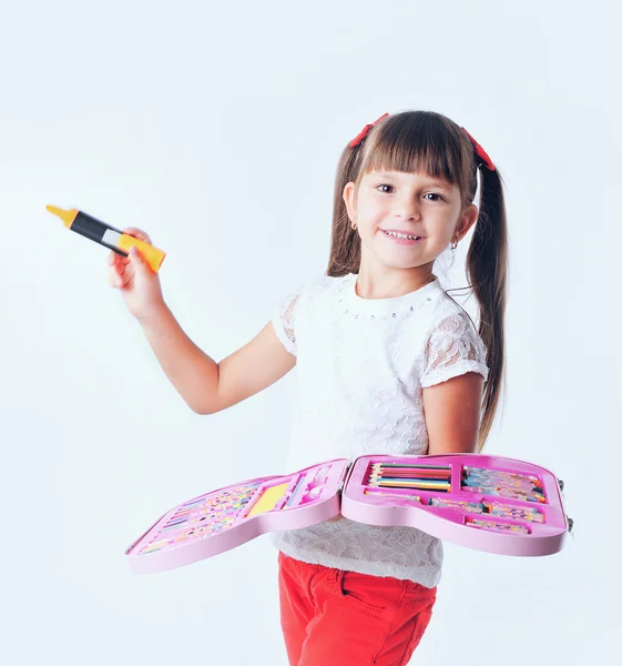 Little girl schoolboy draws with colored markers — Stock Photo, Image