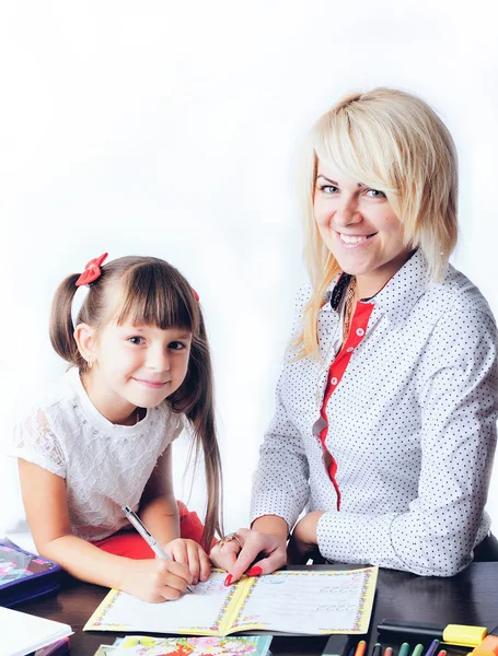 Little girl draws a teenage student decides to write homework wi — Stock Photo, Image
