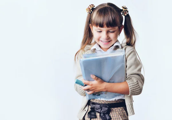 Portrait of teenager girl with school backpack holding colored folders isolated on white background — Stock Photo, Image