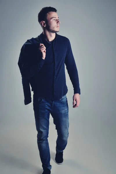 Handsome guy posing in stylish jeans clothes — Stock Photo, Image