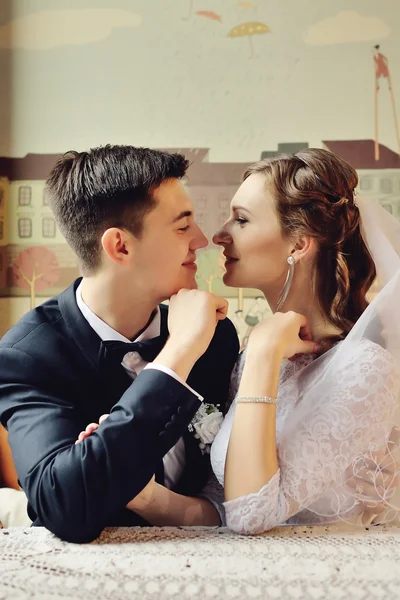 Emotional wedding couple in cafe having fun together.