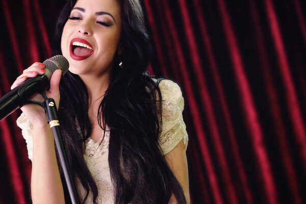 pretty girl singing at the revelry party