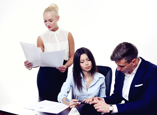 Image of business partners discussing documents and ideas at meeting. Work process of business meeting with electronic devices in office.