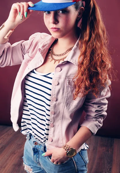 Sexy hip-hop woman in cap with long red hair. Fashion portrait o — Stock Photo, Image