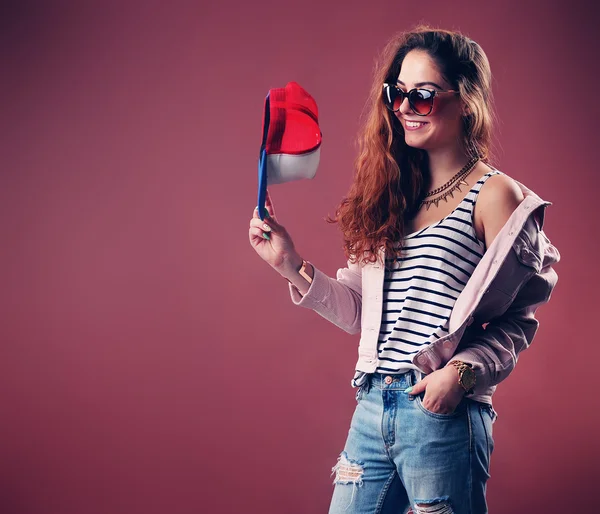 Sexy hip-hop woman in cap with long red hair. Fashion portrait of modern girl in cap — Stock Photo, Image