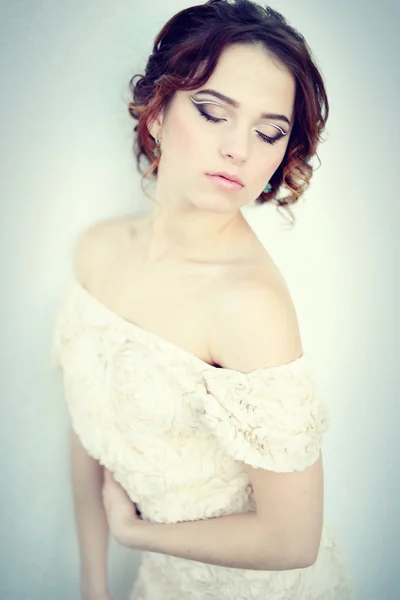 Portrait of the beautiful bride against a window indoors — Stock Photo, Image