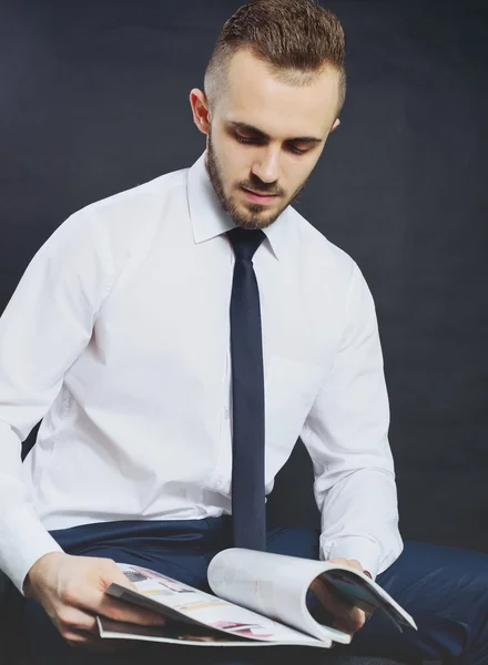 Empresário de sucesso. Retrato de jovem confiante em formalwear olhando para a câmera e sorrindo, mantendo os braços cruzados e em pé contra fundo cinza — Fotografia de Stock