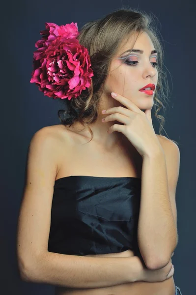 Lente model met bloemen in haar haar en mode make-up. Zomer meisje met trendy make-up en kapsel . — Stockfoto