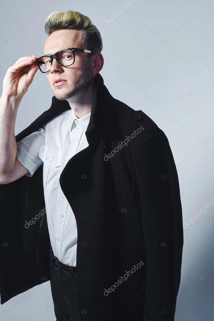 Man with glasses, guy with glasses on a dark background, guy in a black