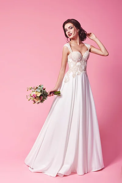Bride.Young moda model mükemmel cilt ve makyaj, bej renkli arka plan, kıvırcık saç, saç çiçekleri