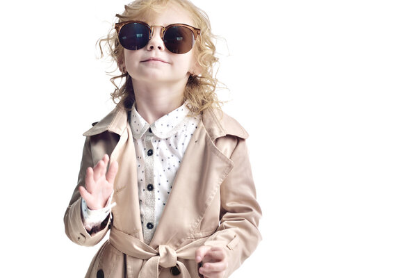 Fashionable child. Girl blonde with glasses