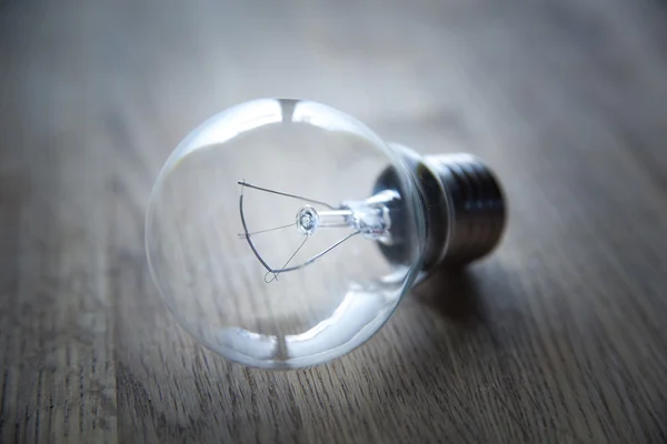 Bulb  on a wooden table Stock Image