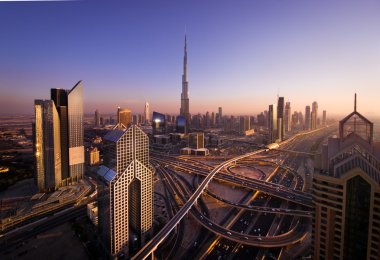 Sunset near Burj Dubai from the roof in city clipart
