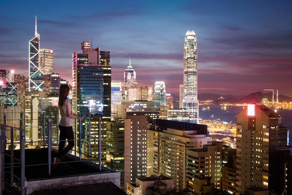 Tity dívka je sledující západ slunce ze střechy Hong Kong — Stock fotografie