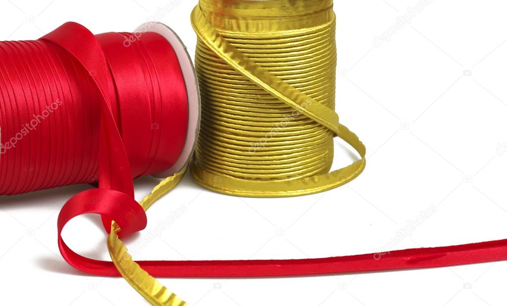 Golden and red bobbins of ribbons - edging, welt
