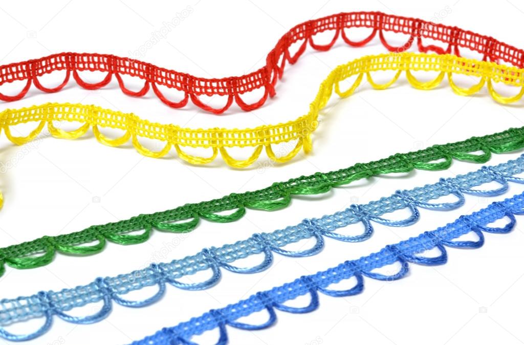 Curved strips of multicolored lace on white background