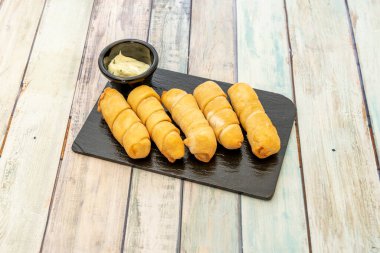 Plate of stuffed cheese sticks fried in olive oil and made with wheat flour