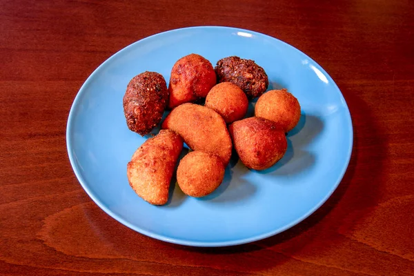 Blue Plate Croquettes Different Flavors Shapes Reddish Wooden Table —  Fotos de Stock