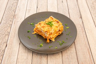 typical chicken lasagna recipe with its pasta sheets separating the different stuffed layers and on the top bechamel and cheese gratin