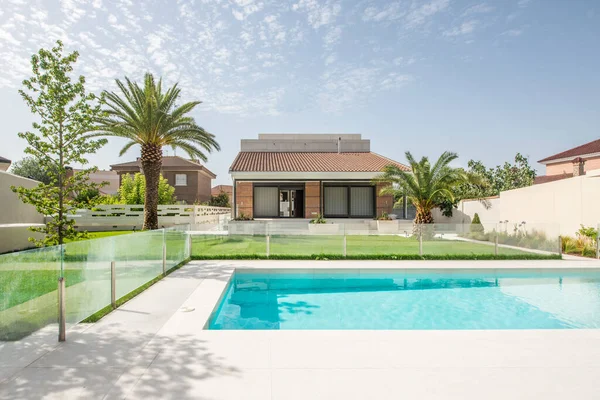 Detached house with pool, garden and palm trees on the outskirts of a city